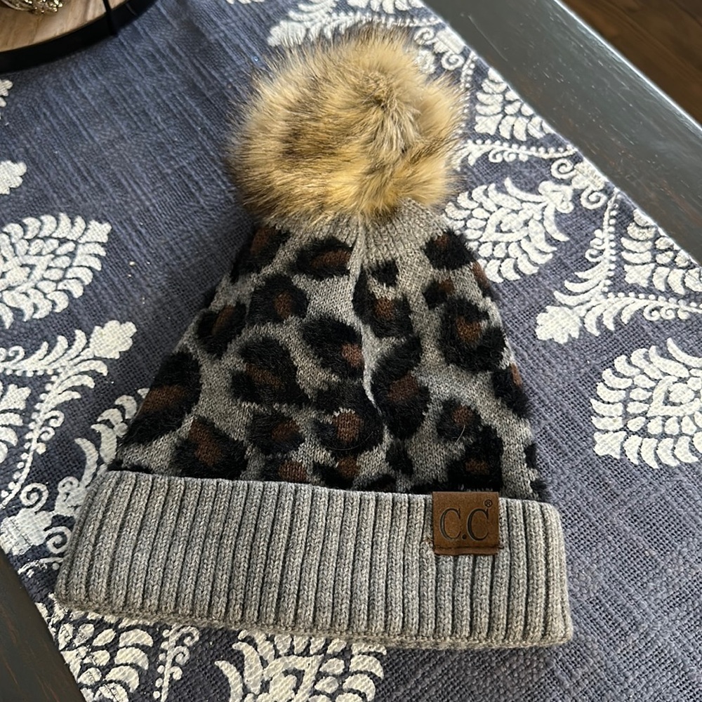 C.C cheetah hat with fluff ball on top